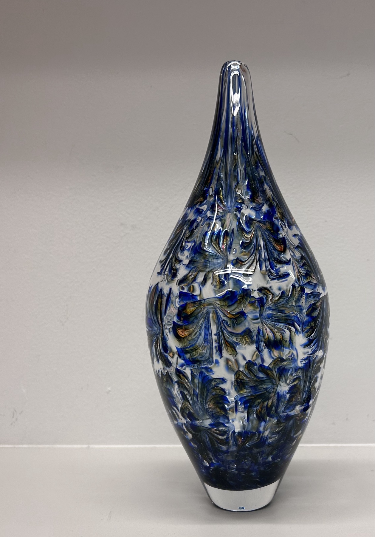 Blue blown glass vessel with feather-like murrine patterning
