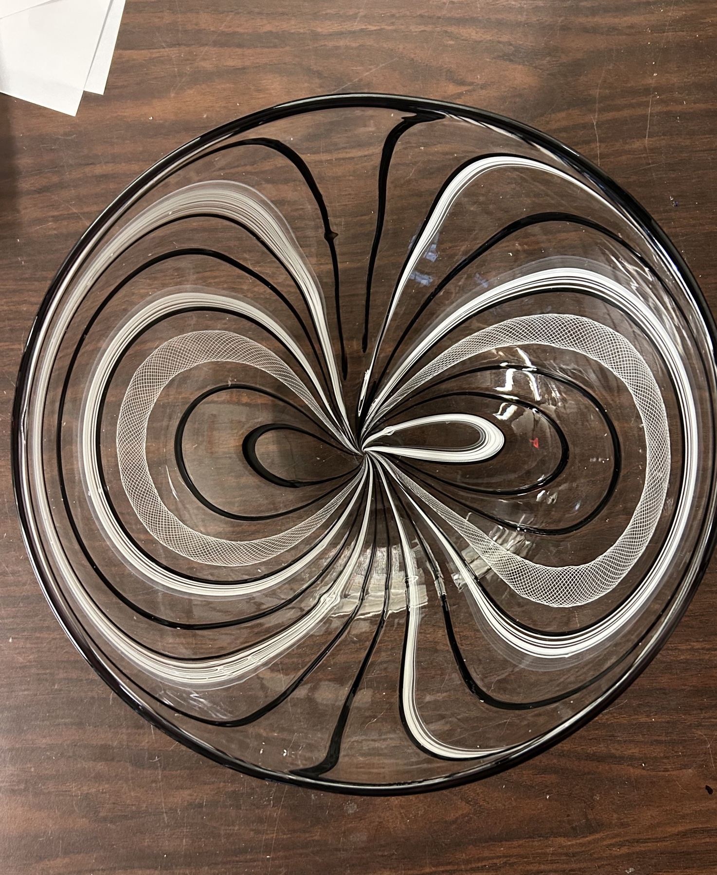 Clear glass bowl with black and white field-line patterning